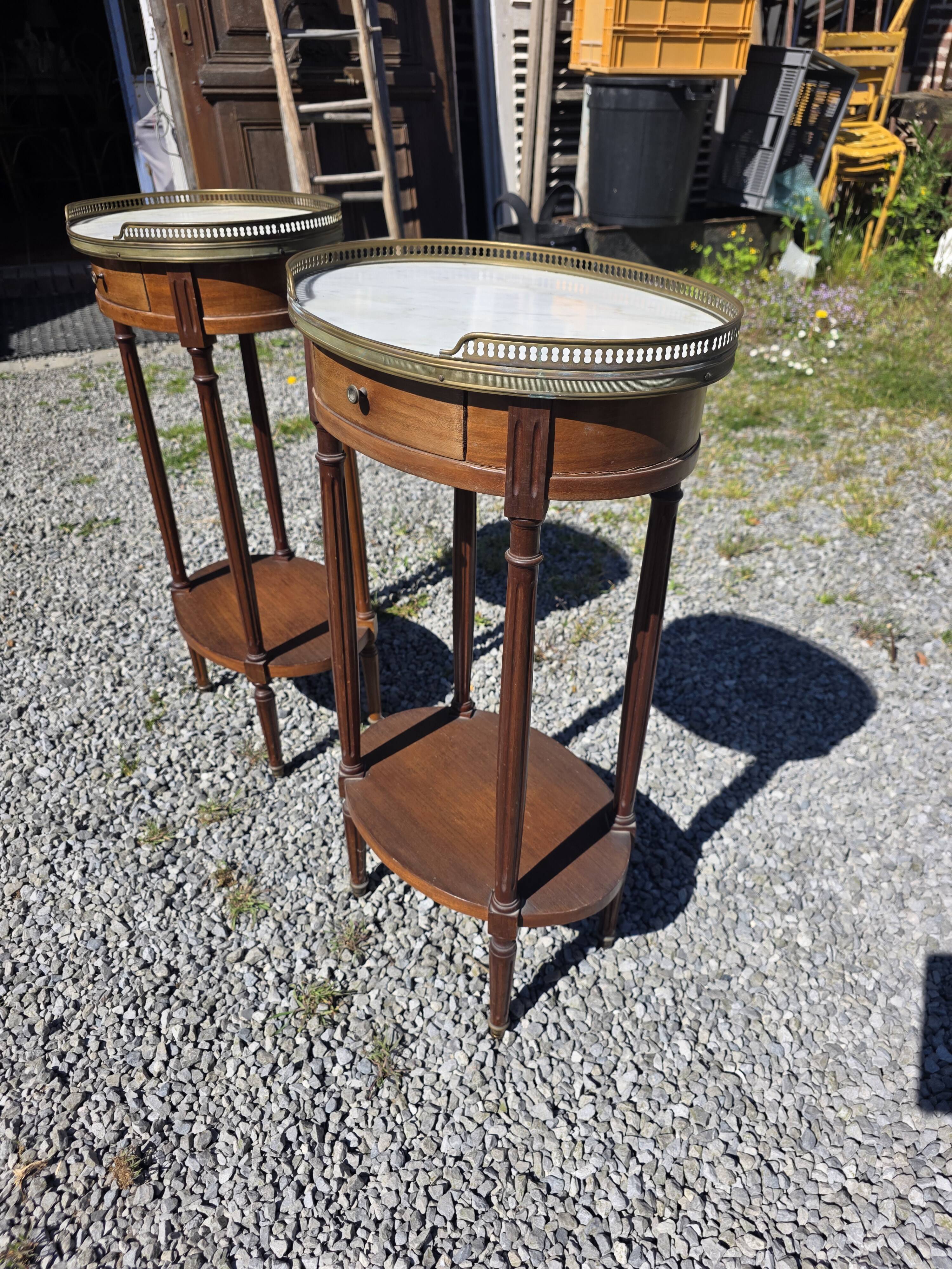 Pair of Louis XVI style bedside tables in mahogany, with marble tops.