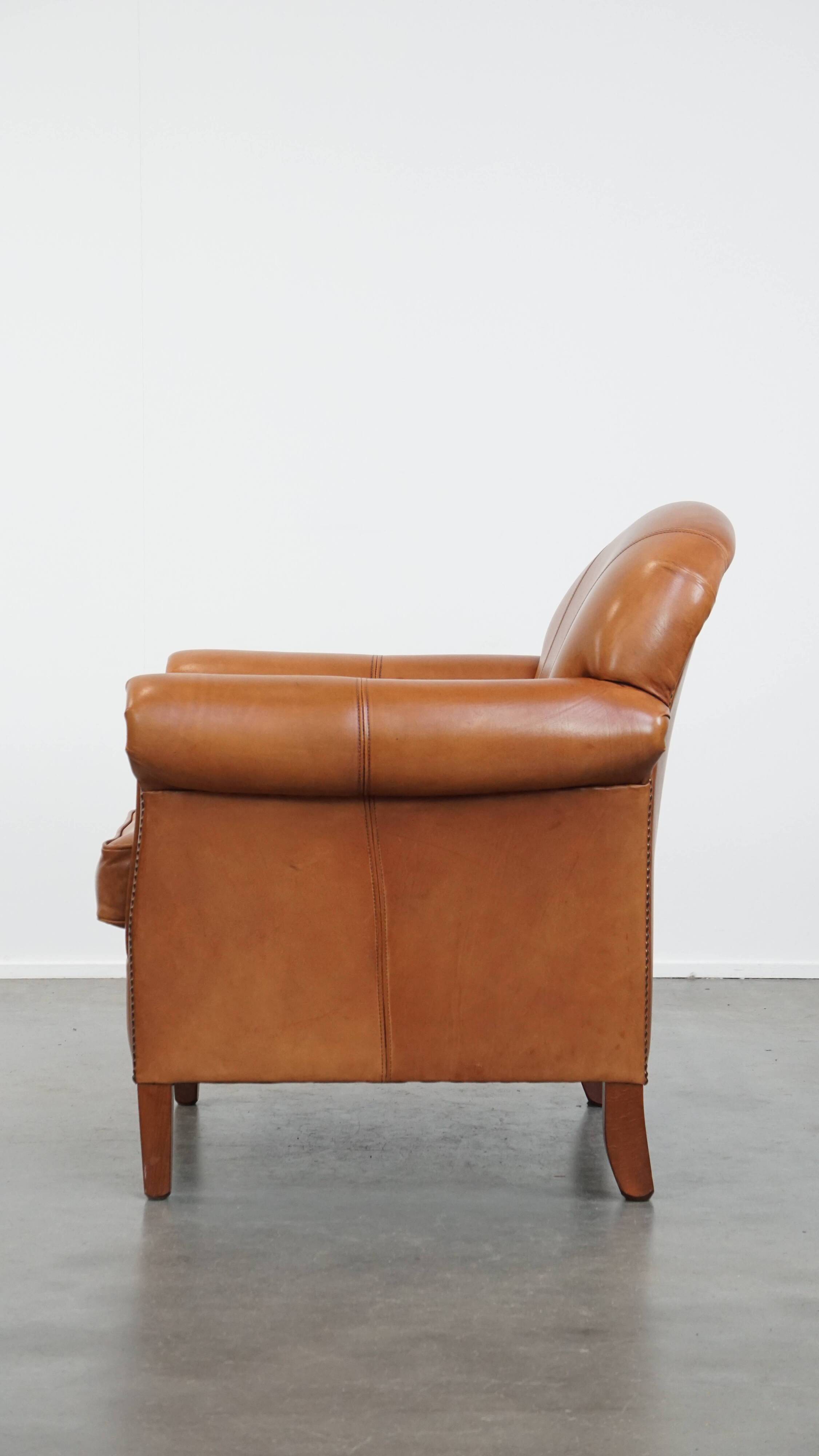 Cognac-colored cowhide leather armchair