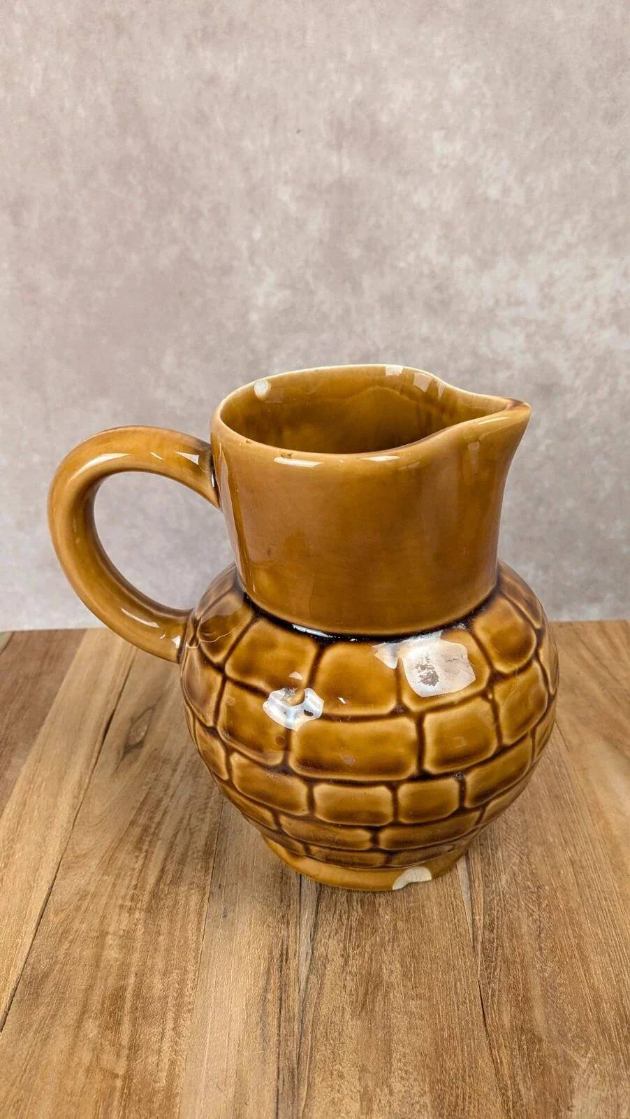 Vintage Sarreguemines pitcher with brown relief decoration.
