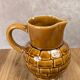 Vintage Sarreguemines pitcher with brown relief decoration.