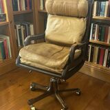 Vintage mahogany and havana leather office chair with wheels from around 1970.