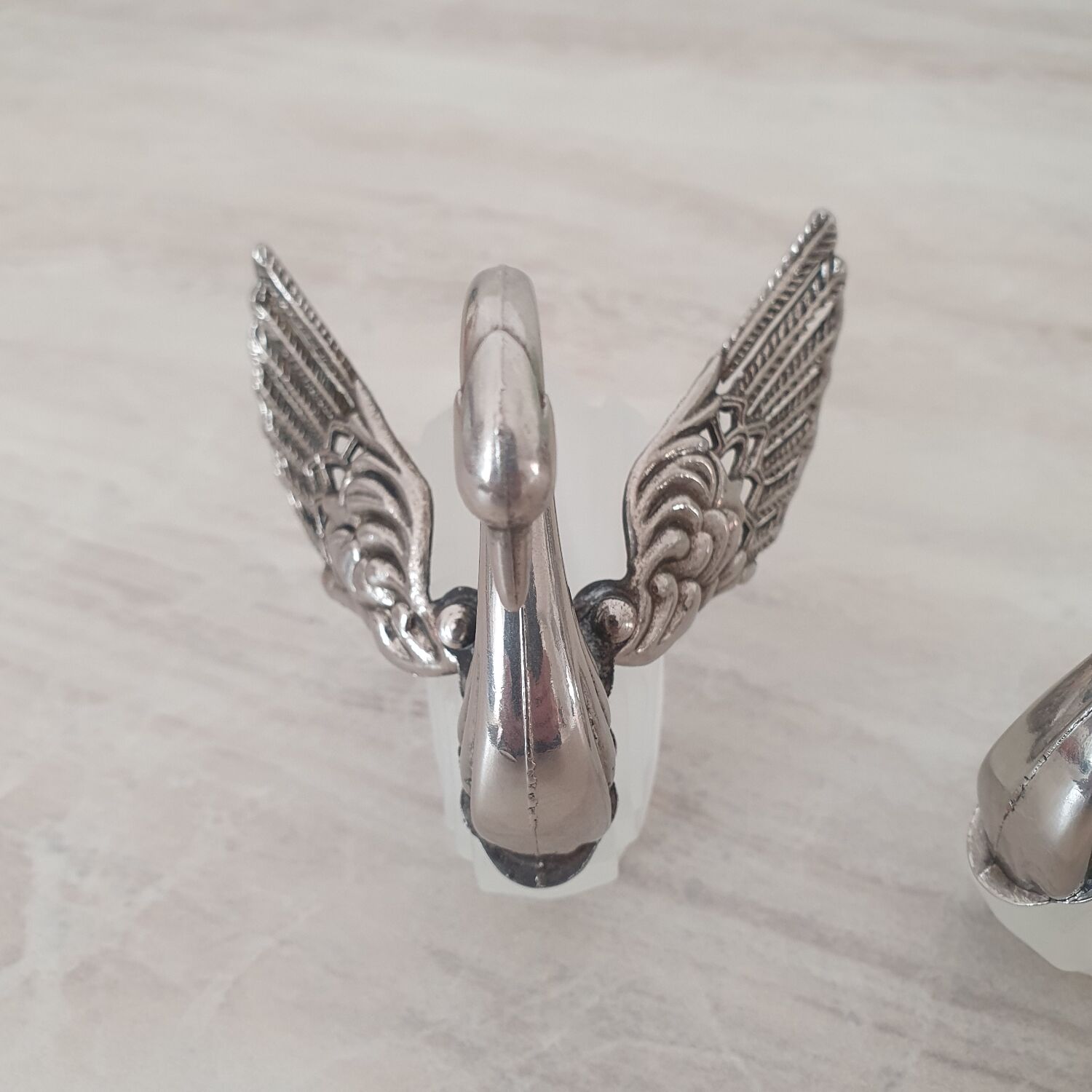 Two frosted glass swan salt cellars with silver plating.
