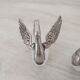 Two frosted glass swan salt cellars with silver plating.