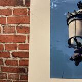 Photograph of young people on a lamppost.