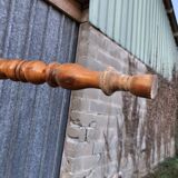 Antique farmhouse table in solid cherry wood with turned legs.
