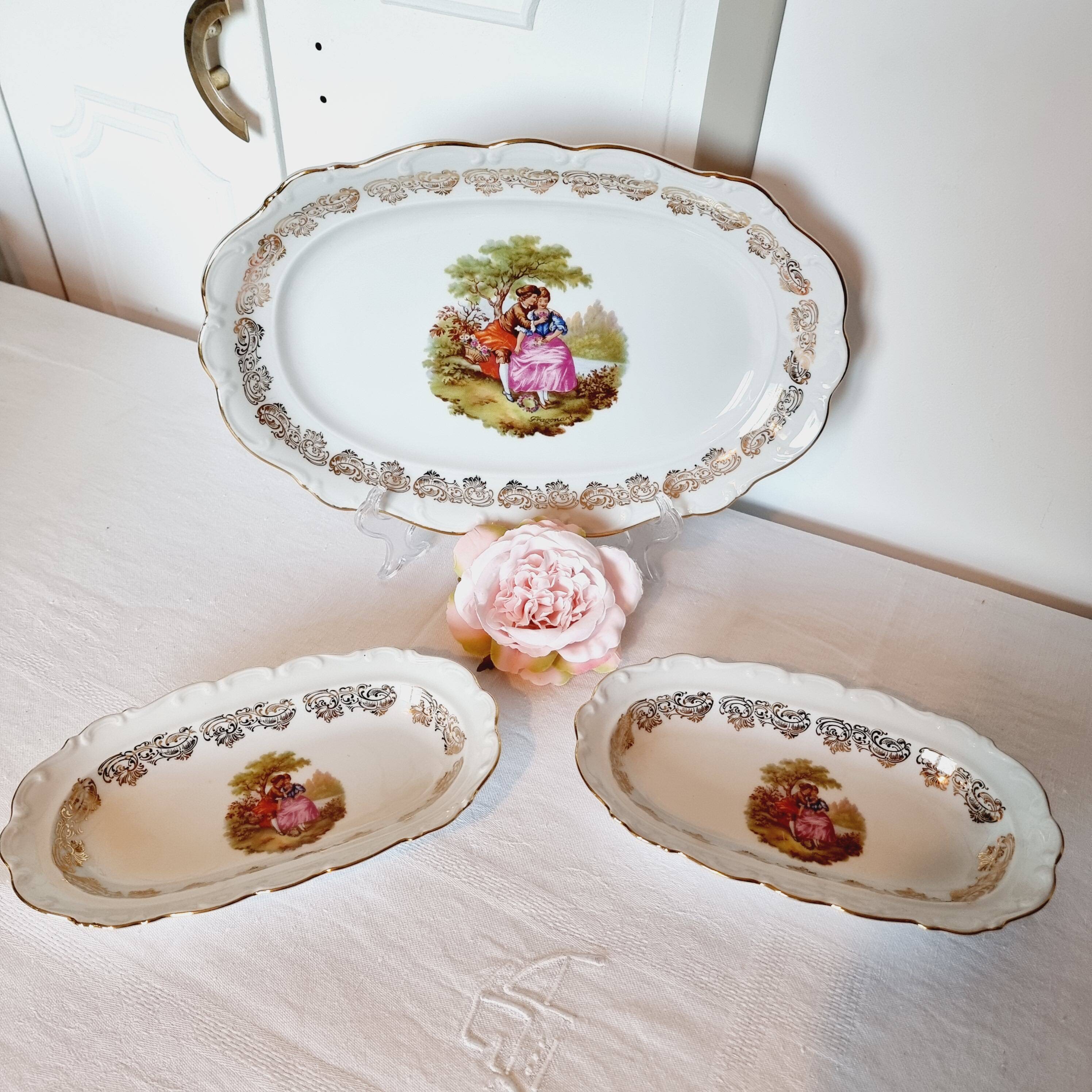 3 serving dishes with frangonard romantic scene with designs and borders in 24 carat gold.