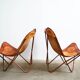 Set of 2 vintage Butterfly chairs in brown leather with a metal frame.