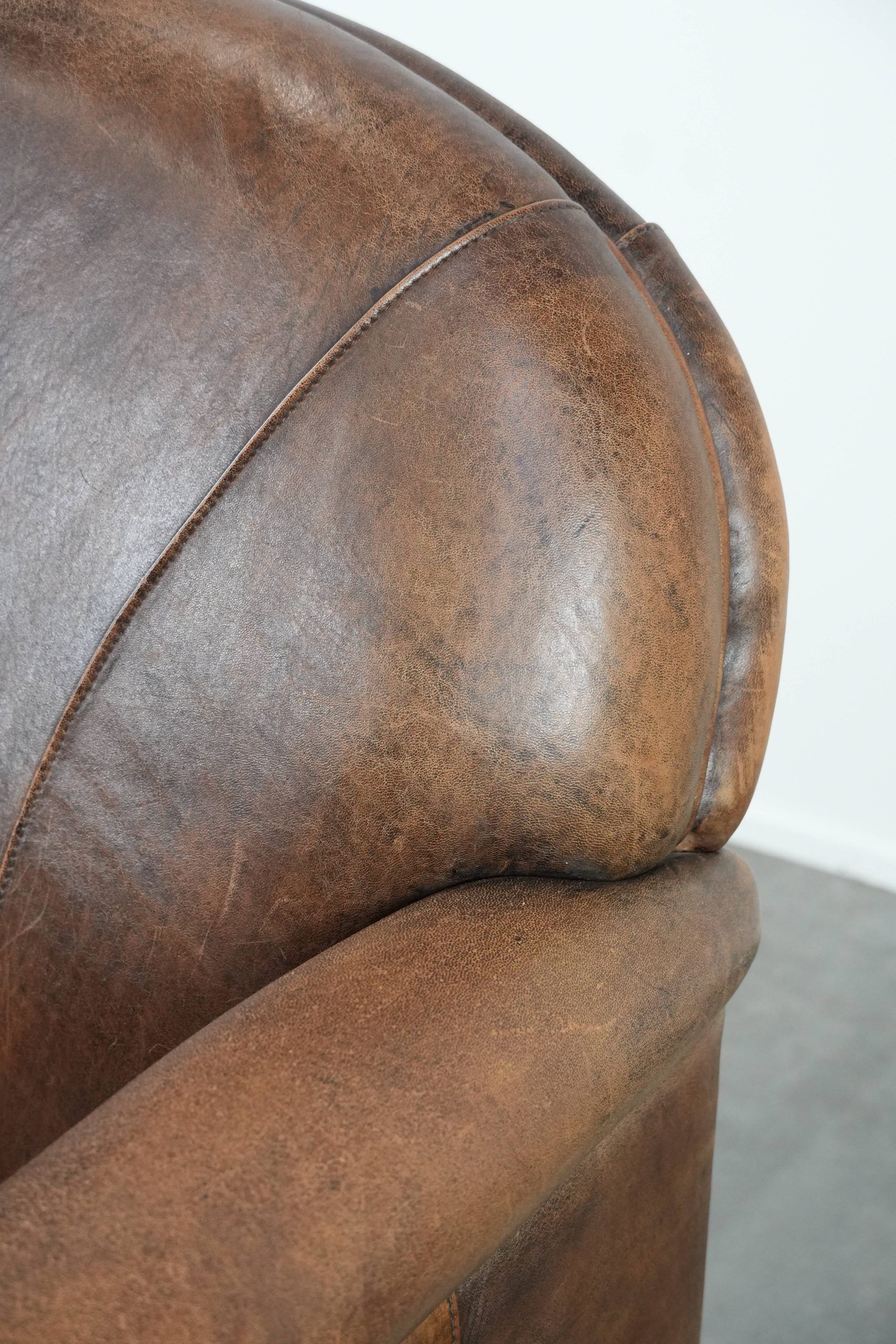 Vintage sheepskin armchair with warm colours and a characterful appearance