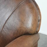 Vintage sheepskin armchair with warm colours and a characterful appearance