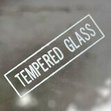 Modernist tripod side table in tempered glass and chrome metal.