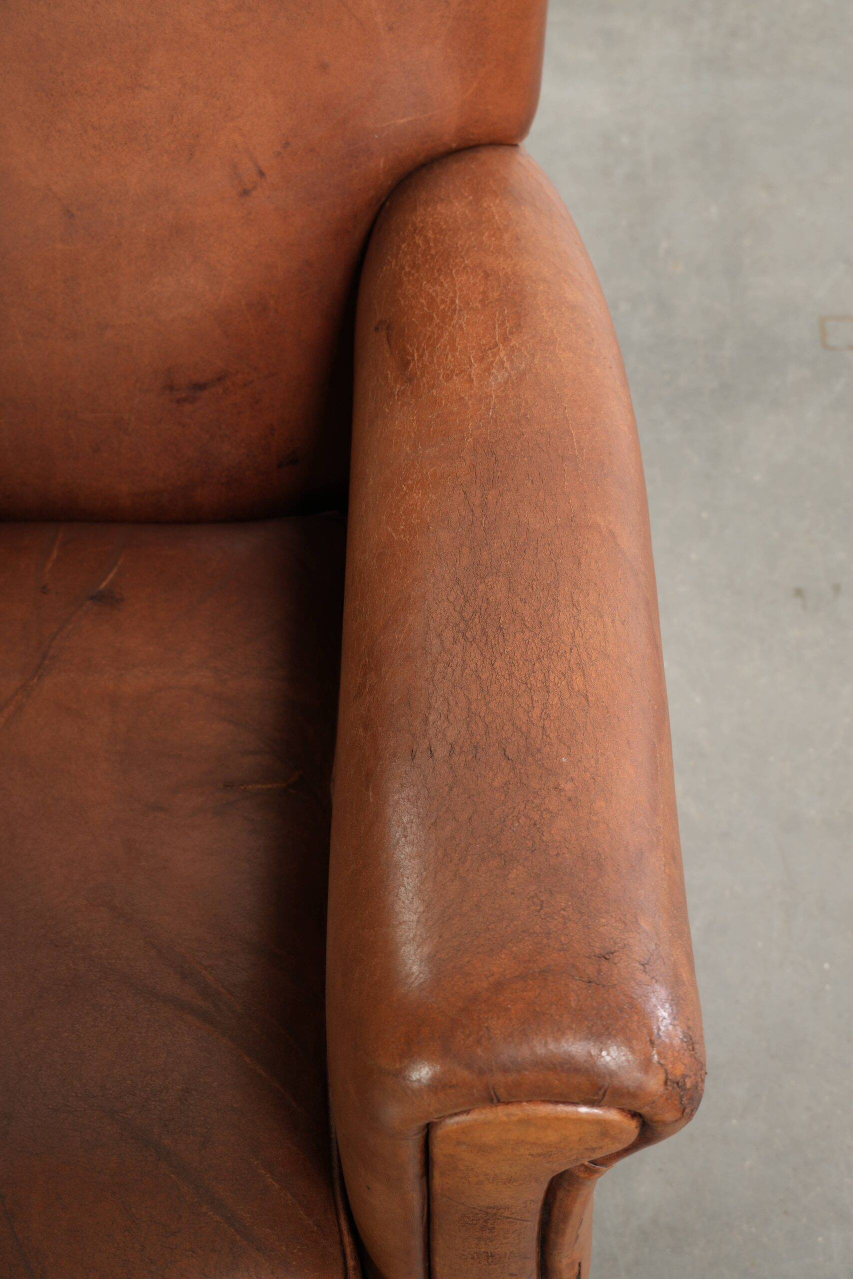 Sturdy vintage sheepskin armchair with a beautiful cognac colour