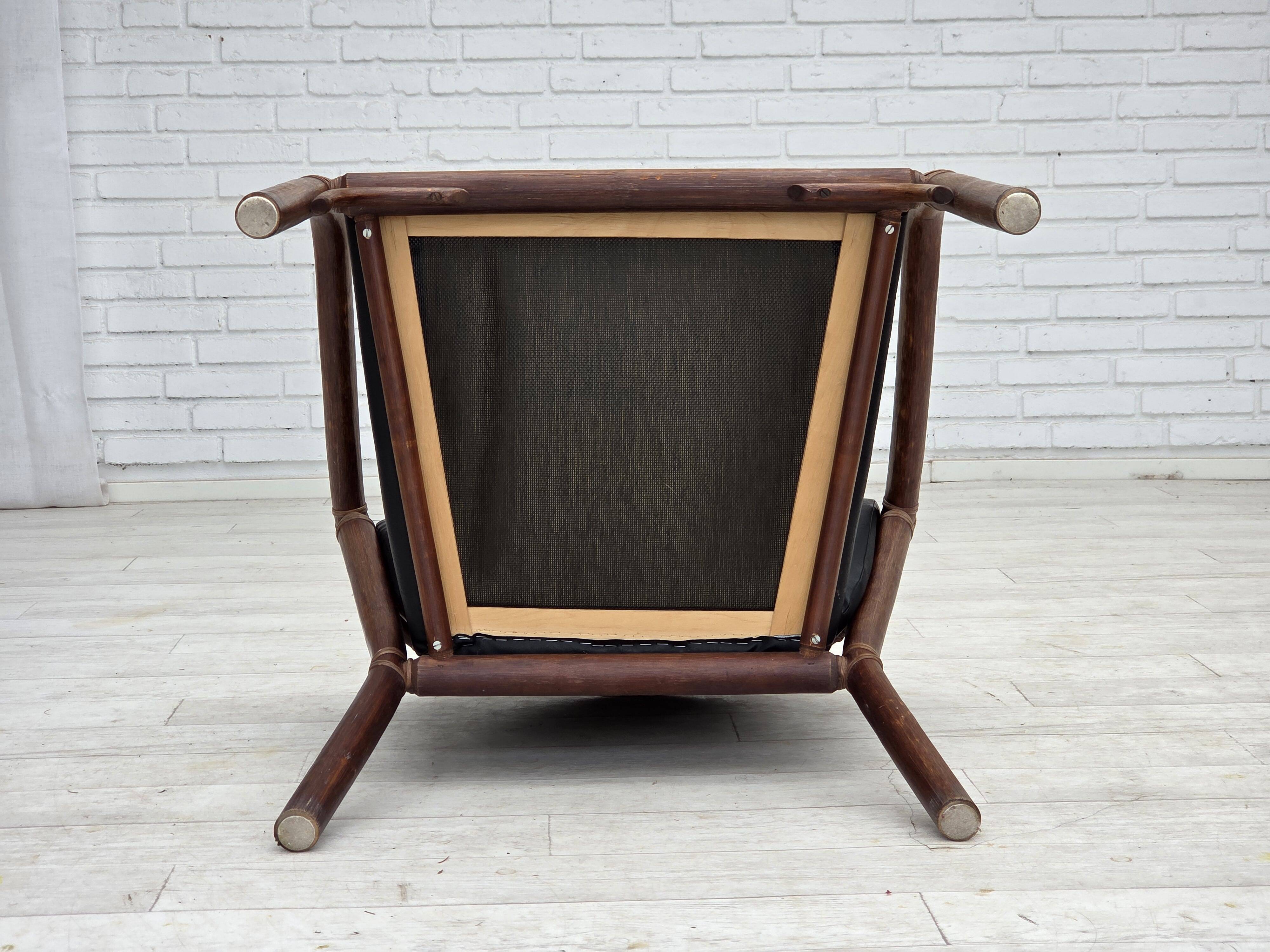 1970s, Danish armchair, rattan, black artificial leather.