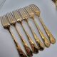 12 Table Forks in gold metal