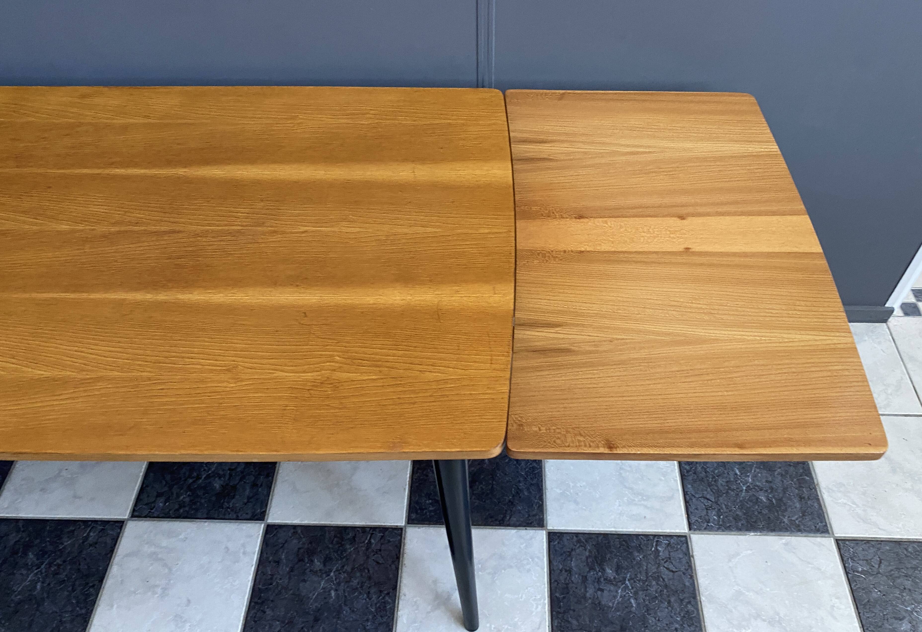 Wood enlarging dining table black wood legs 1960s