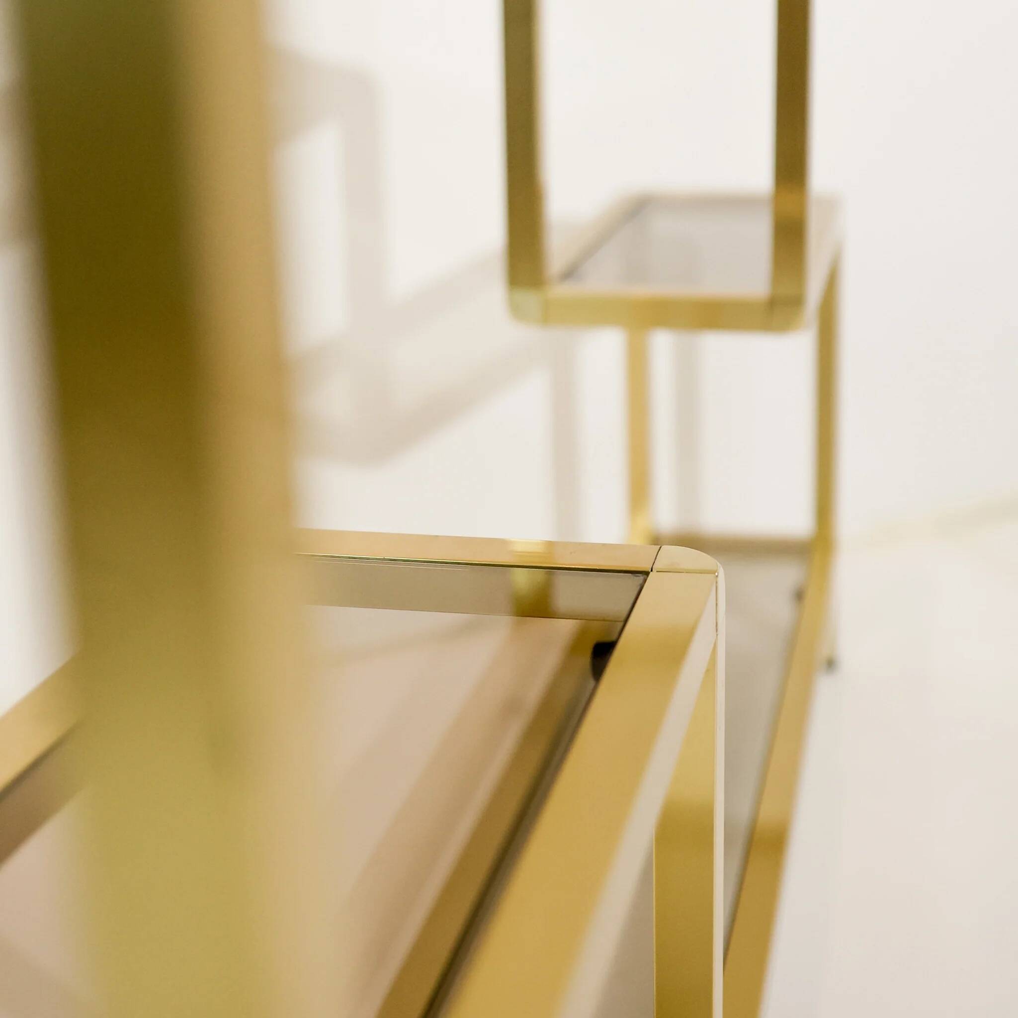 Vintage shelves in brass and smoked glass.