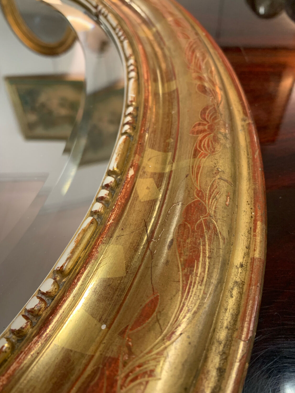 Golden oval mirror