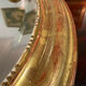 Golden oval mirror