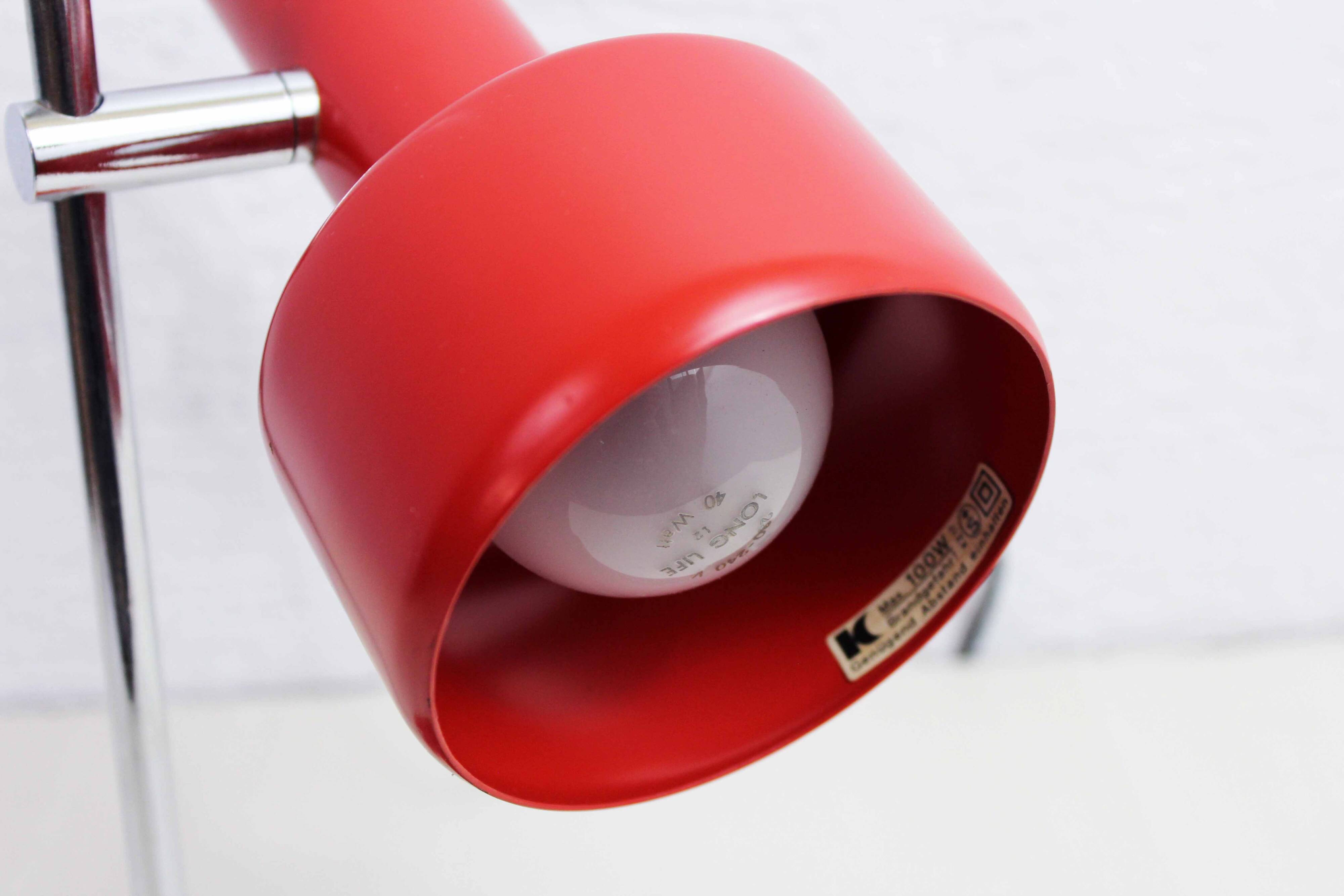 Red metal articulated desk lamp