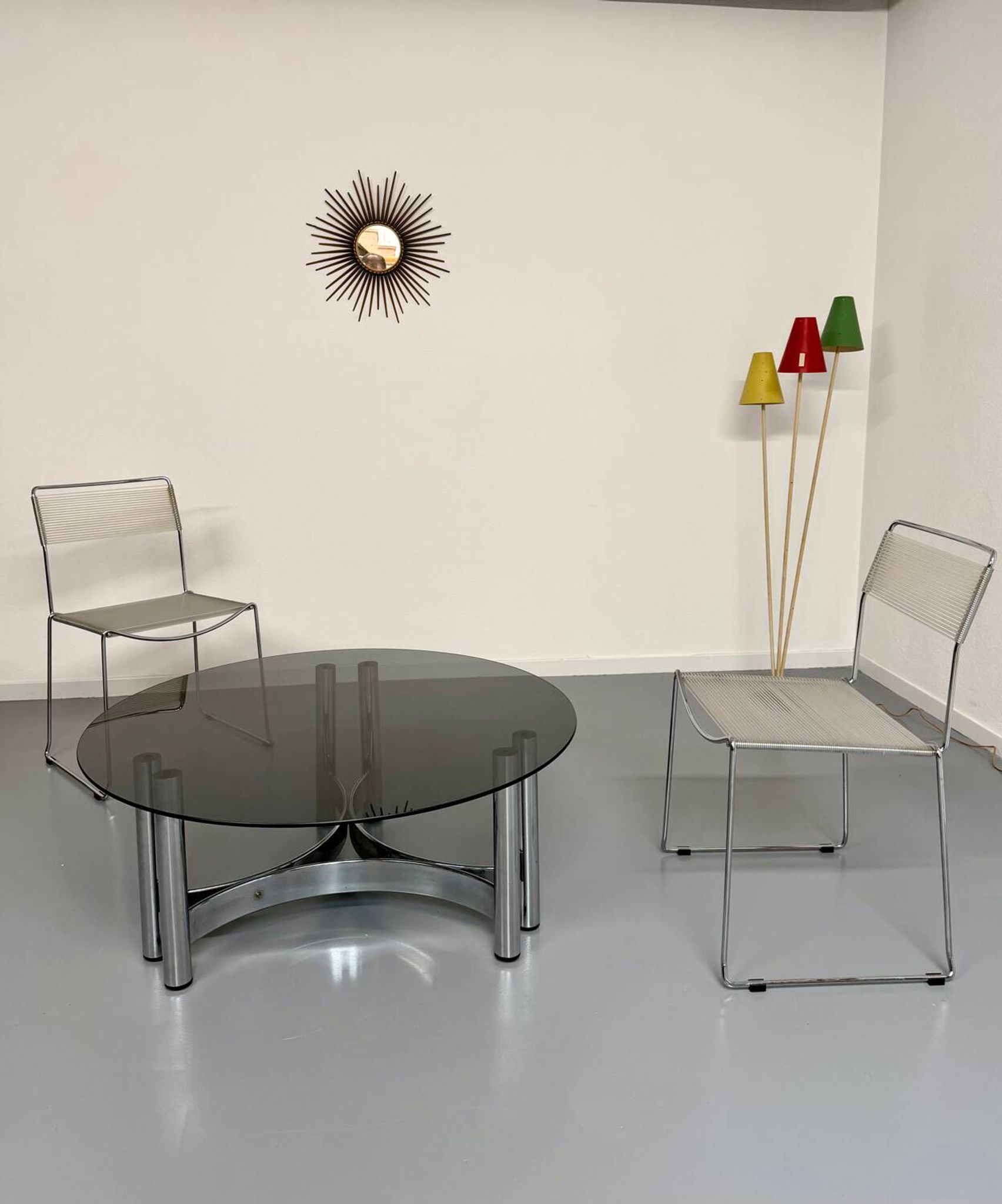Round coffee table in smoked glass and chrome steel, 1970s design.