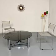 Round coffee table in smoked glass and chrome steel, 1970s design.