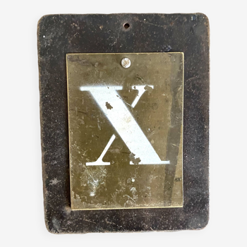 Letter x on brass and metal plates