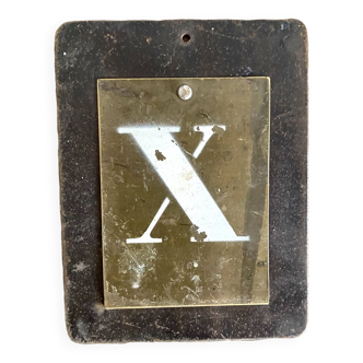 Letter x on brass and metal plates