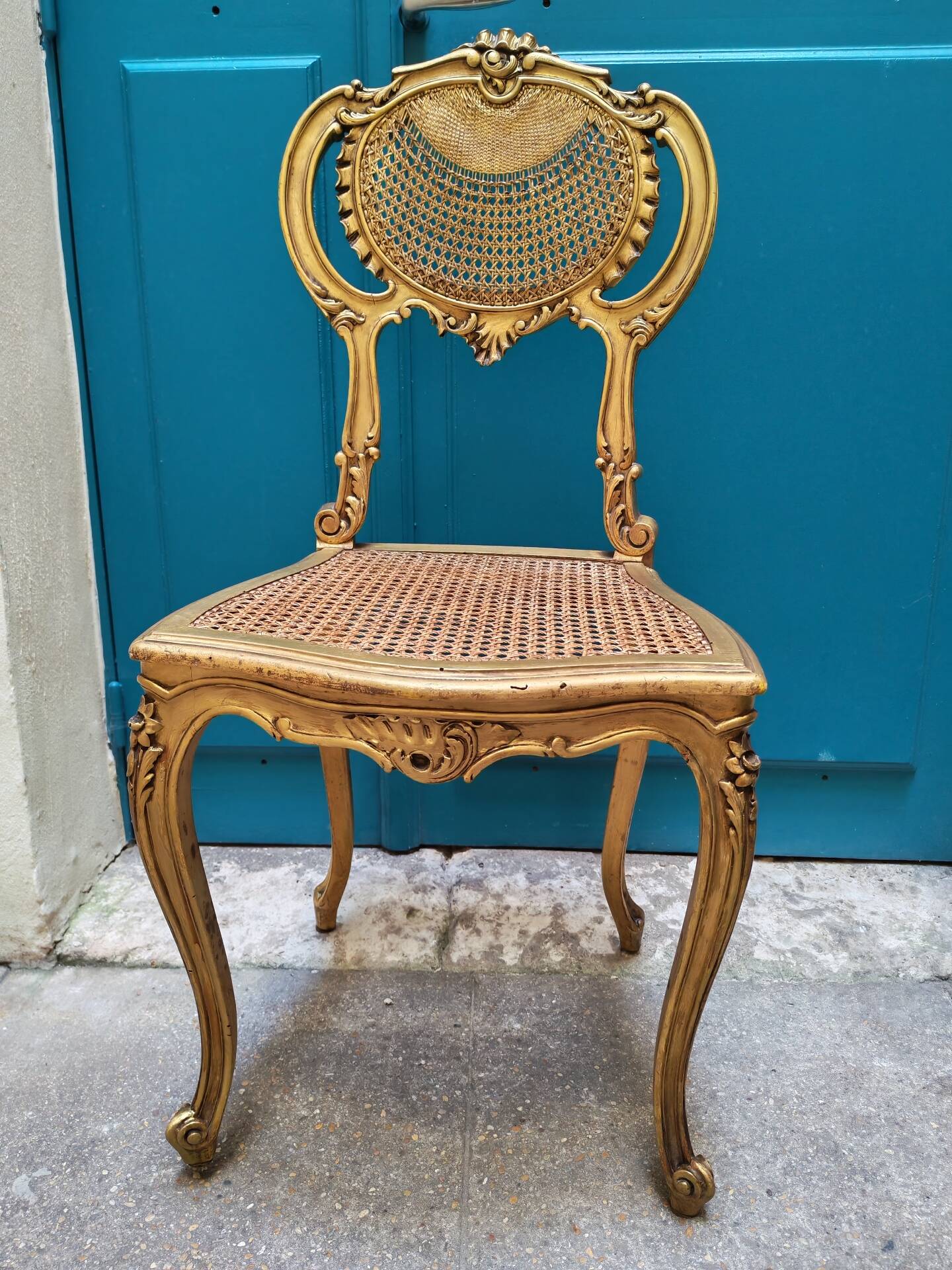 Antique rococo chair in gilded wood and caning