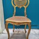 Antique rococo chair in gilded wood and caning