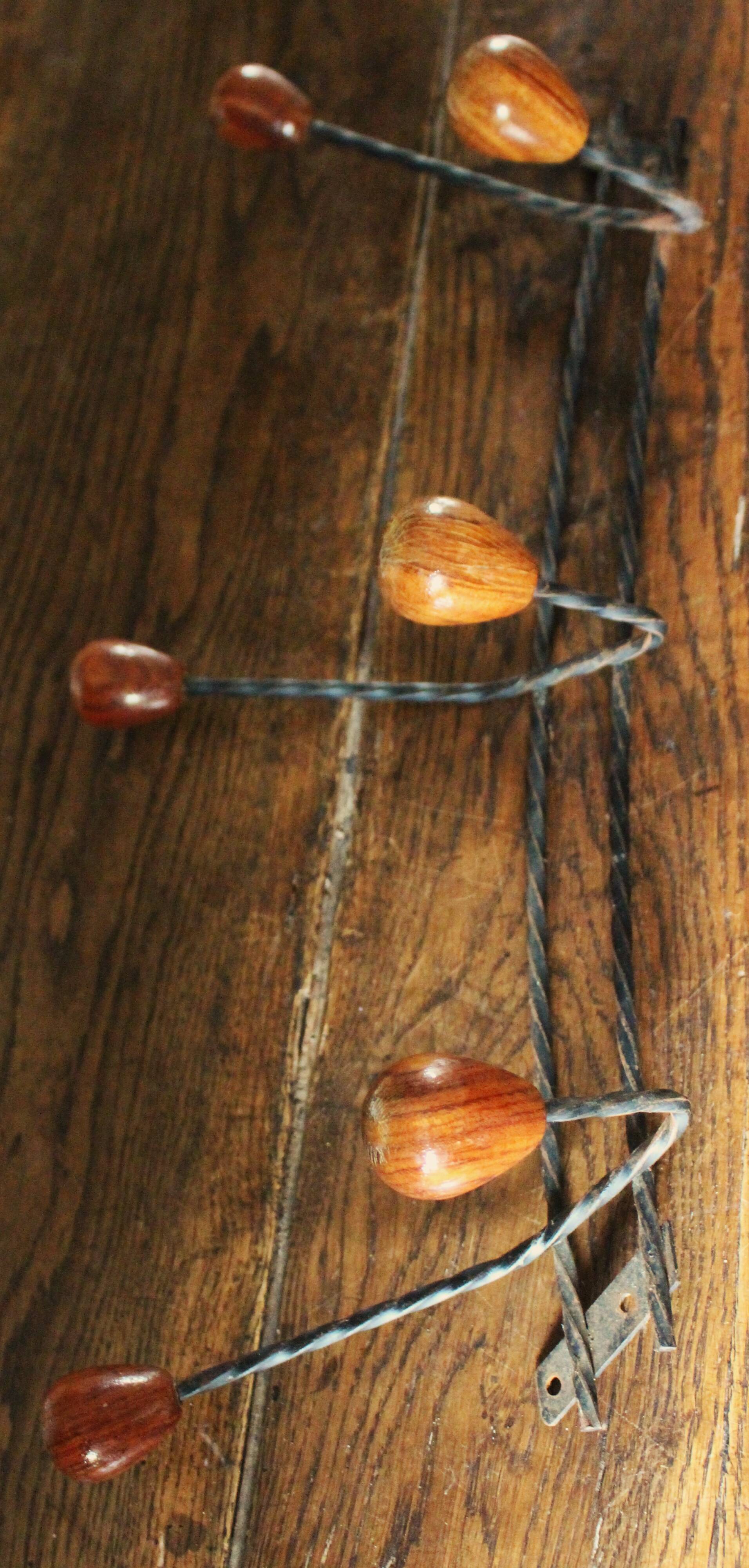 Double wrought iron coat rack with 3 double wooden ball hooks