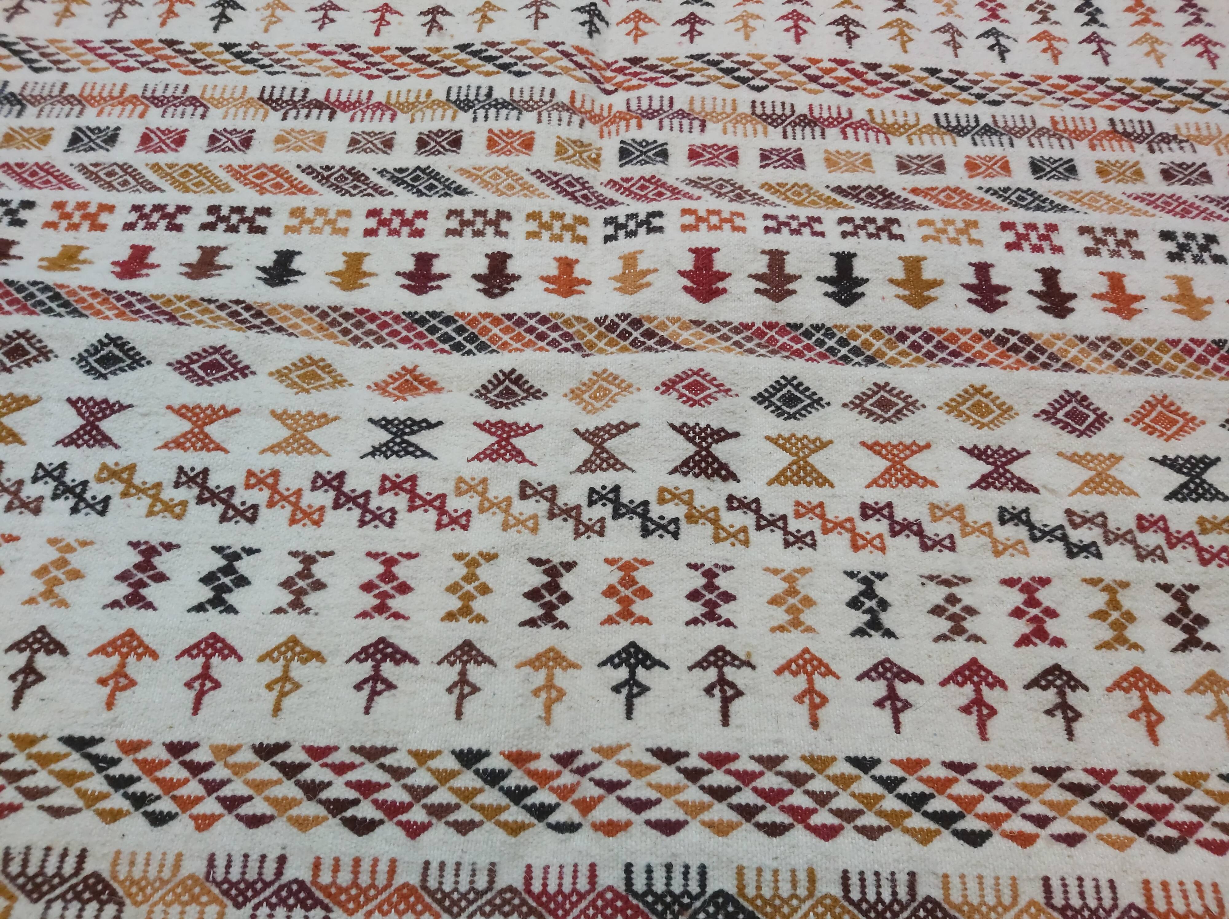 White carpet with multicolored Berber patterns