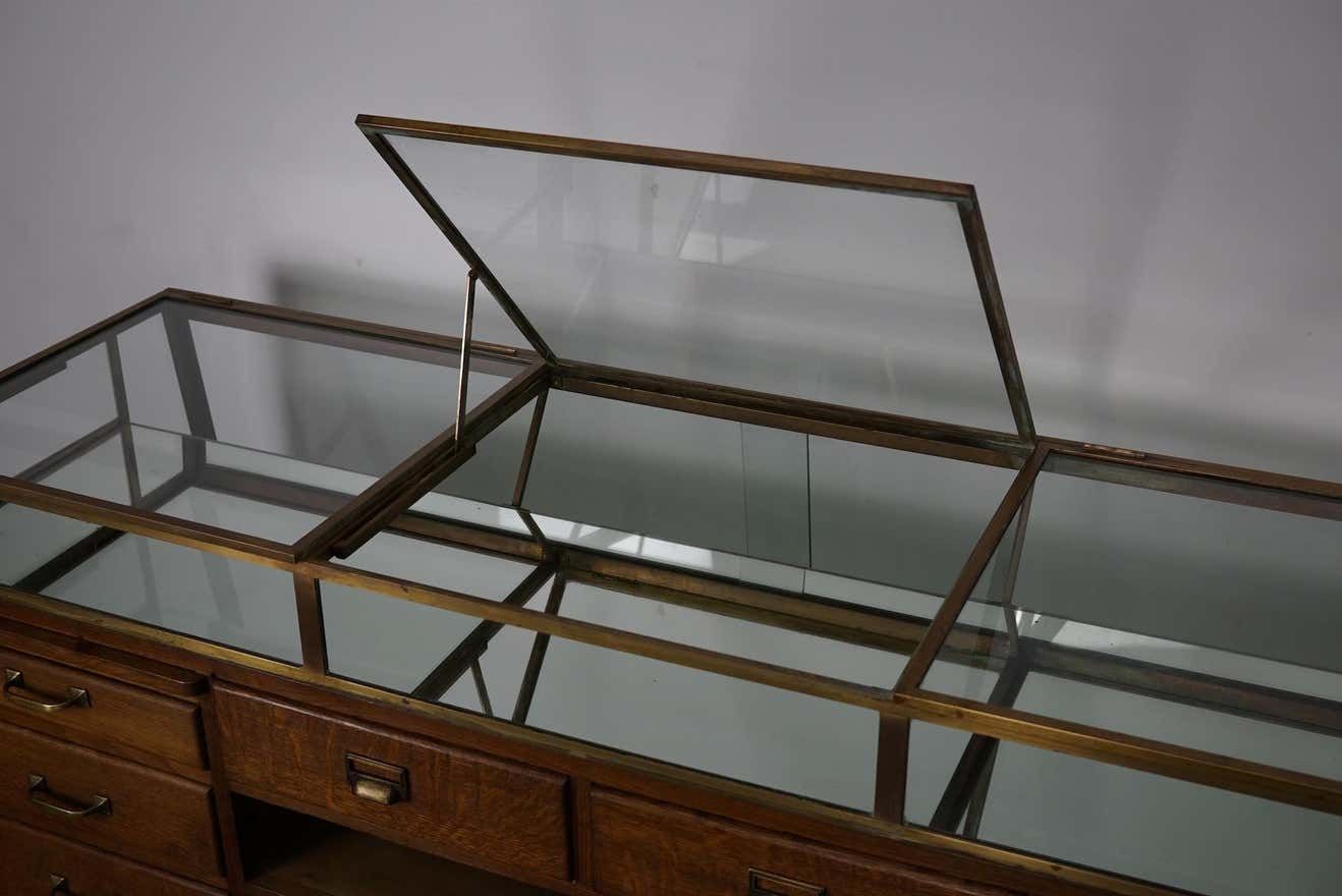 Counter or shop window in oak glass and brass France around 1920