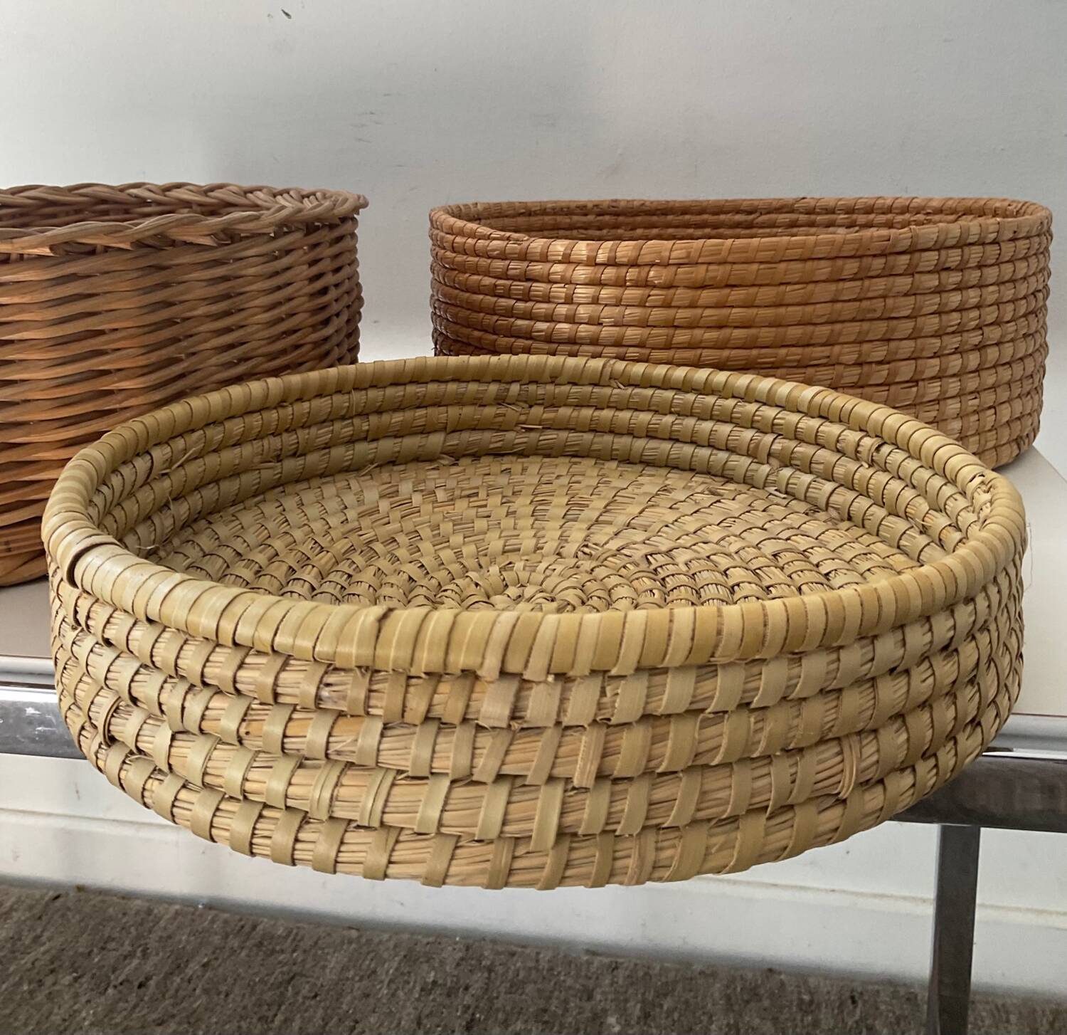Trio of vintage wicker and woven raffia baskets