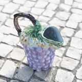 Old bunch pitcher of dabbling grapes