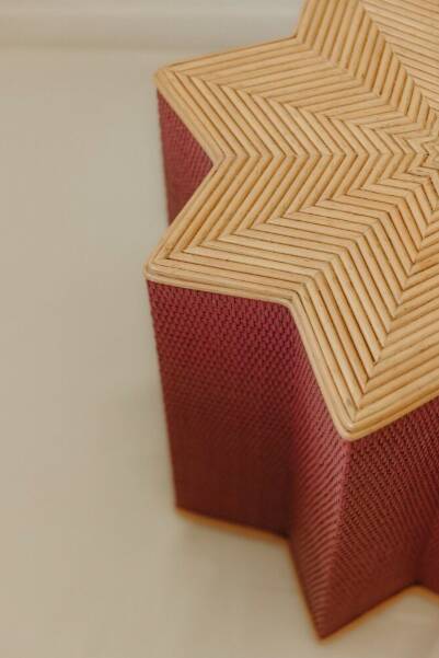 Small star-shaped side table in pink rattan