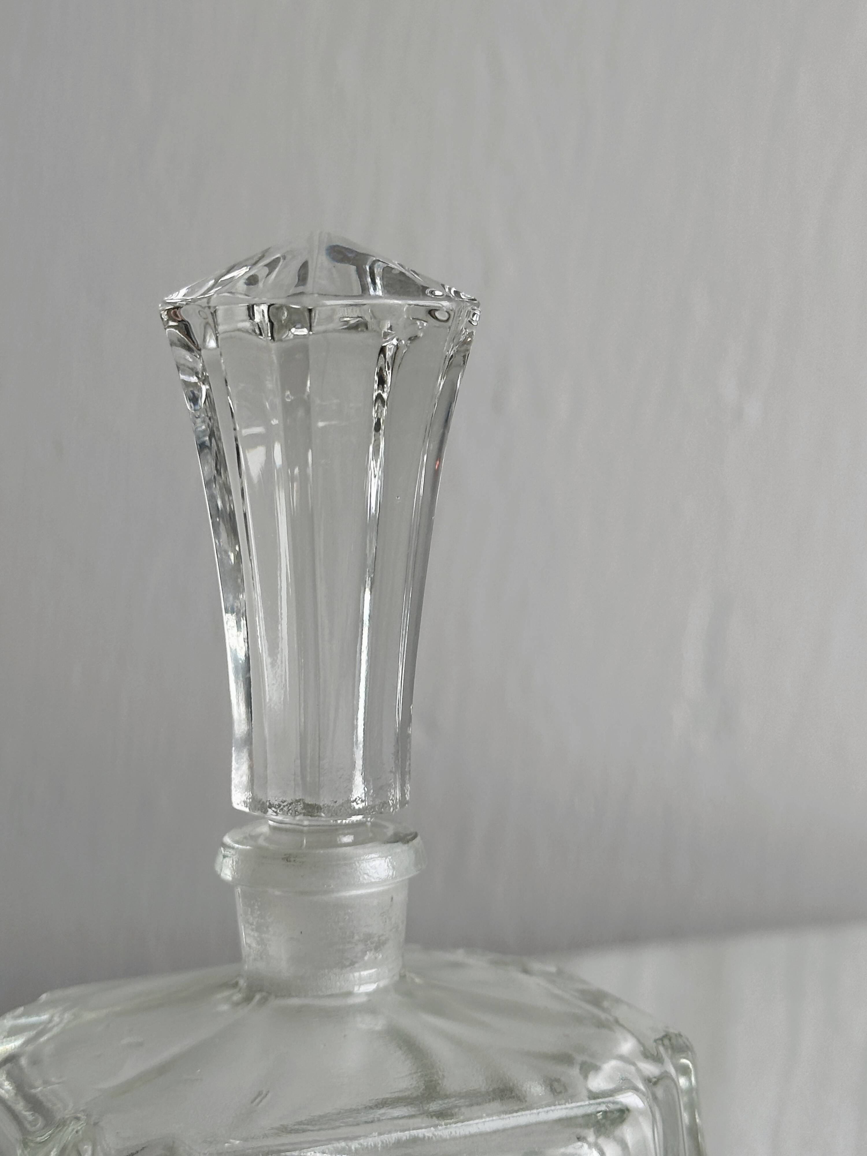 Small transparent faceted glass bottle