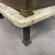 Brass bedside table with a marble top.