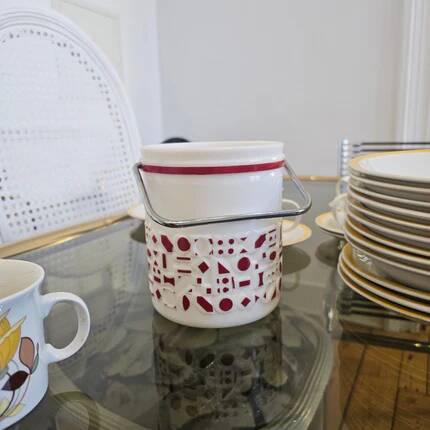 Vintage white opaline ice bucket with red patterns.