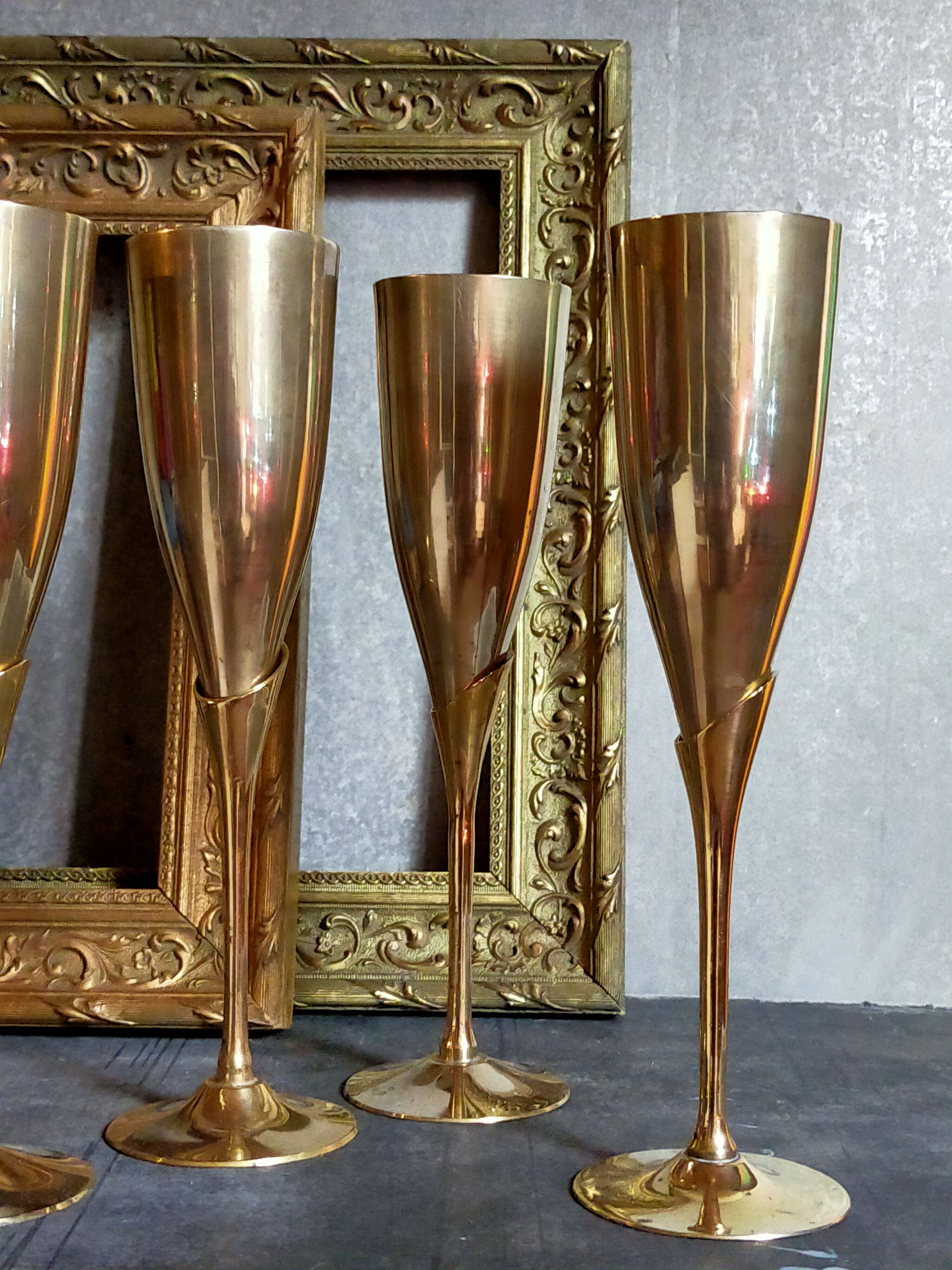 Six brass champagne coupes