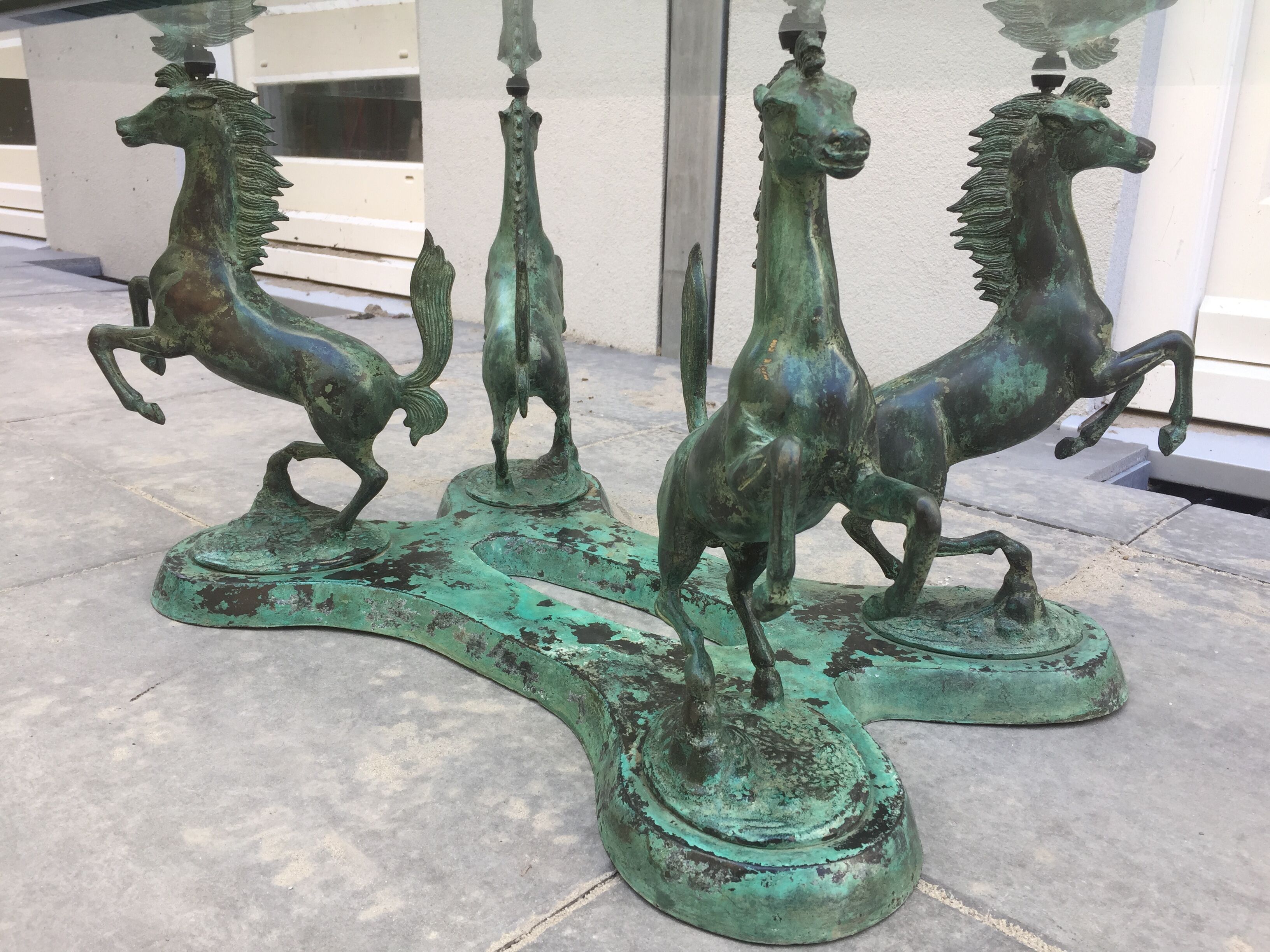 Coffee table with glass plate and bronze horses