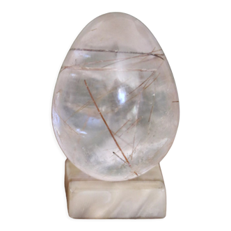 Hand-polished vintage rock crystal quartz egg with white jade support