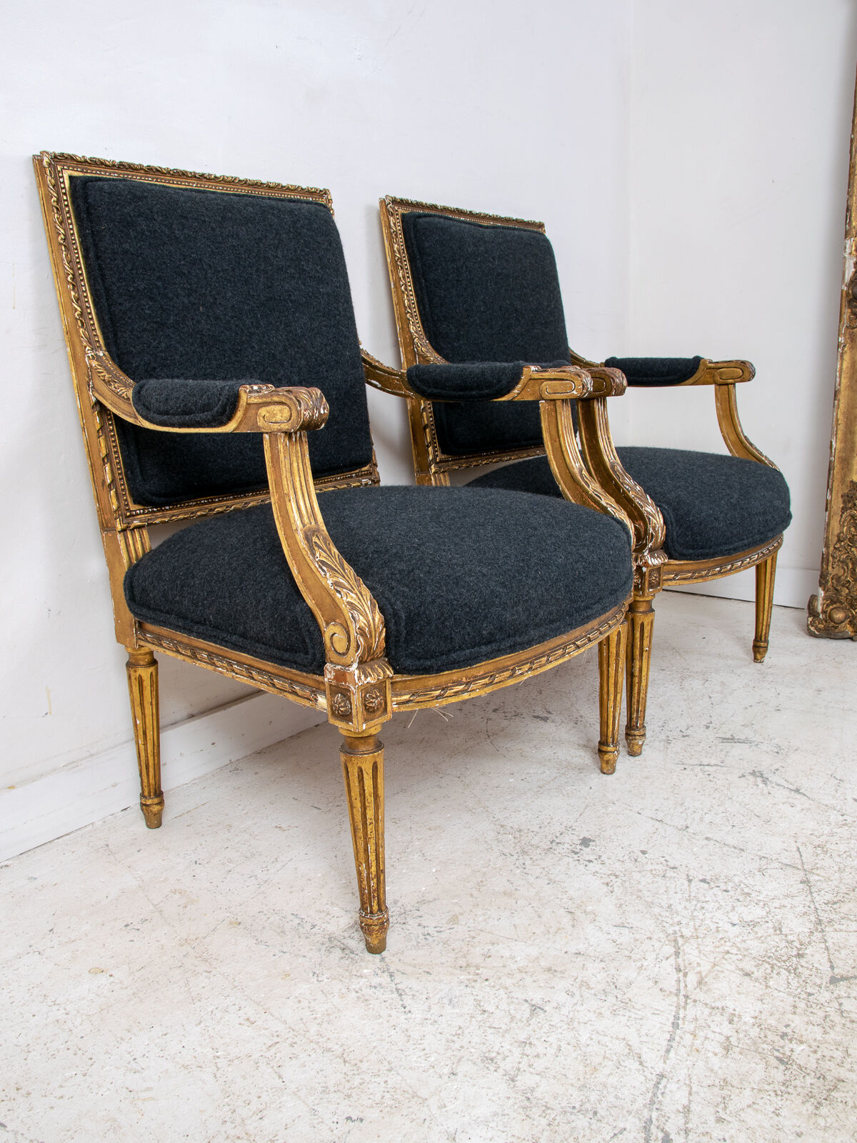 Pair of 19th century Louis XVI gilt armchairs newly re upholstered in holland and sherry fabric