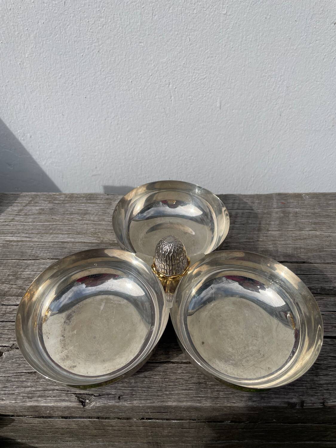 Silver-plated metal dish topped with an acorn
