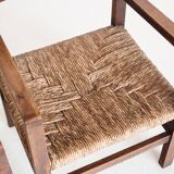 Pair of rustic armchairs in solid wood and straw seats. France, 1940s