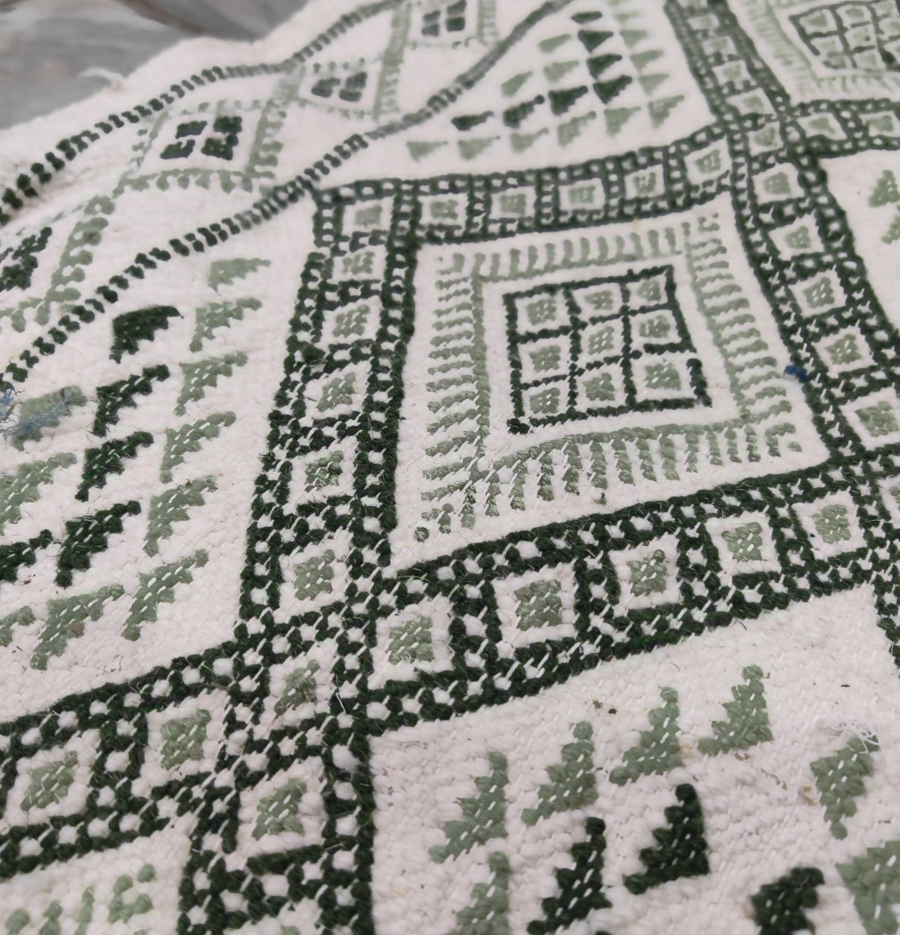 Handwoven white and green rug