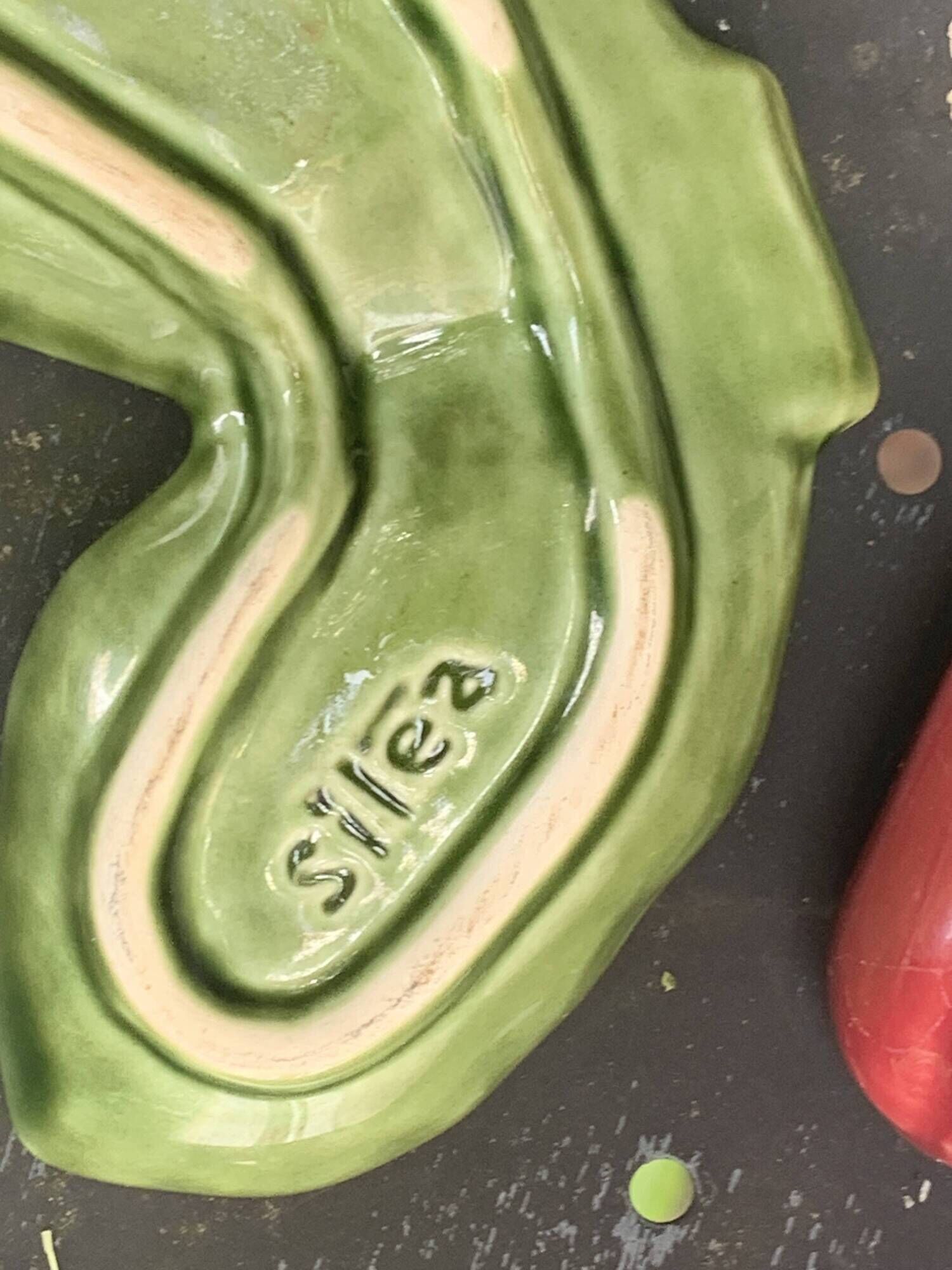 Ceramic salt shakers, slip in the shape of peppers.