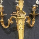 Pair of gilt bronze wall sconces with three lights in the Louis XVI style.