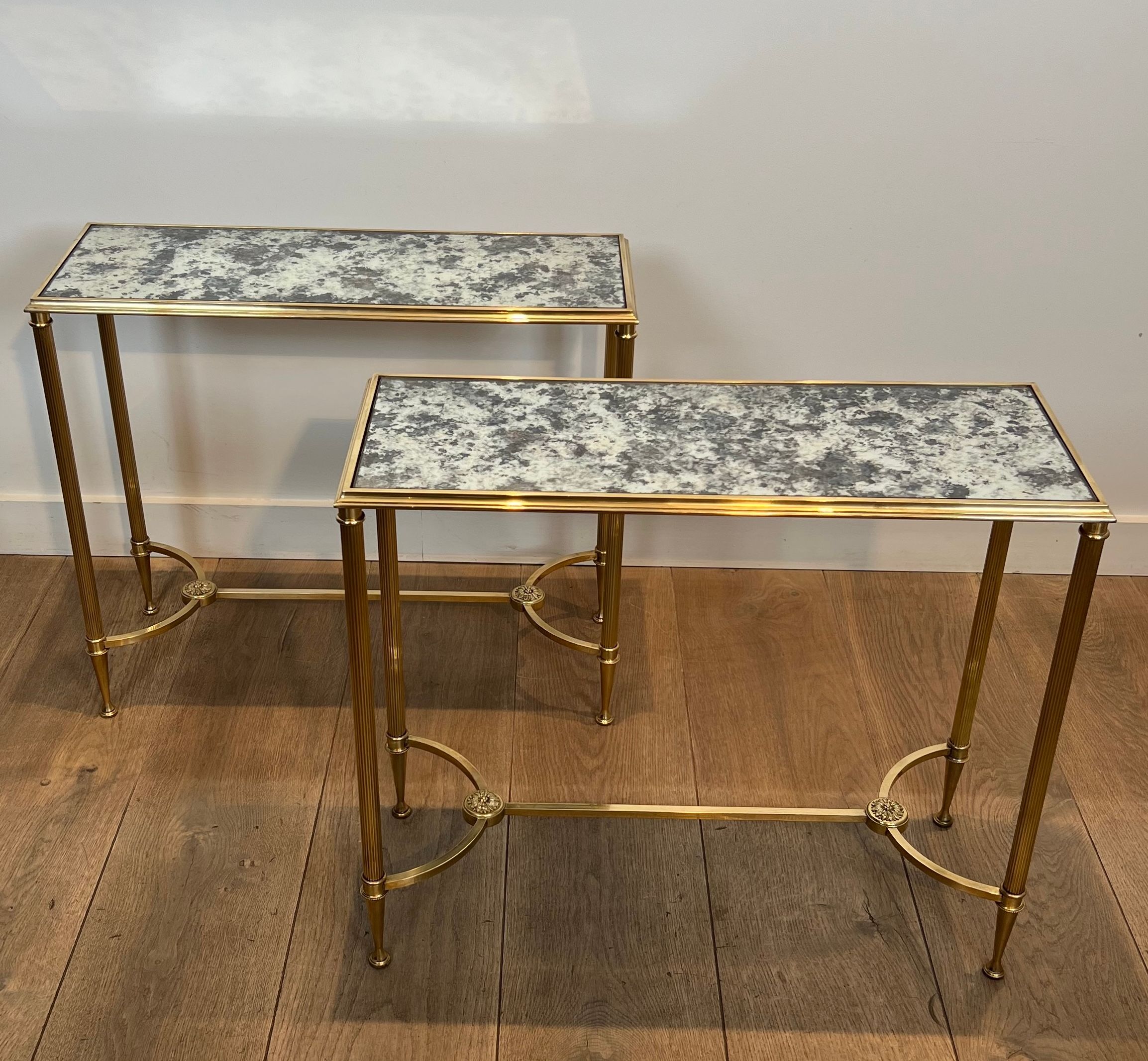Pair of brass and antique mirror side tables from the Baguès house.