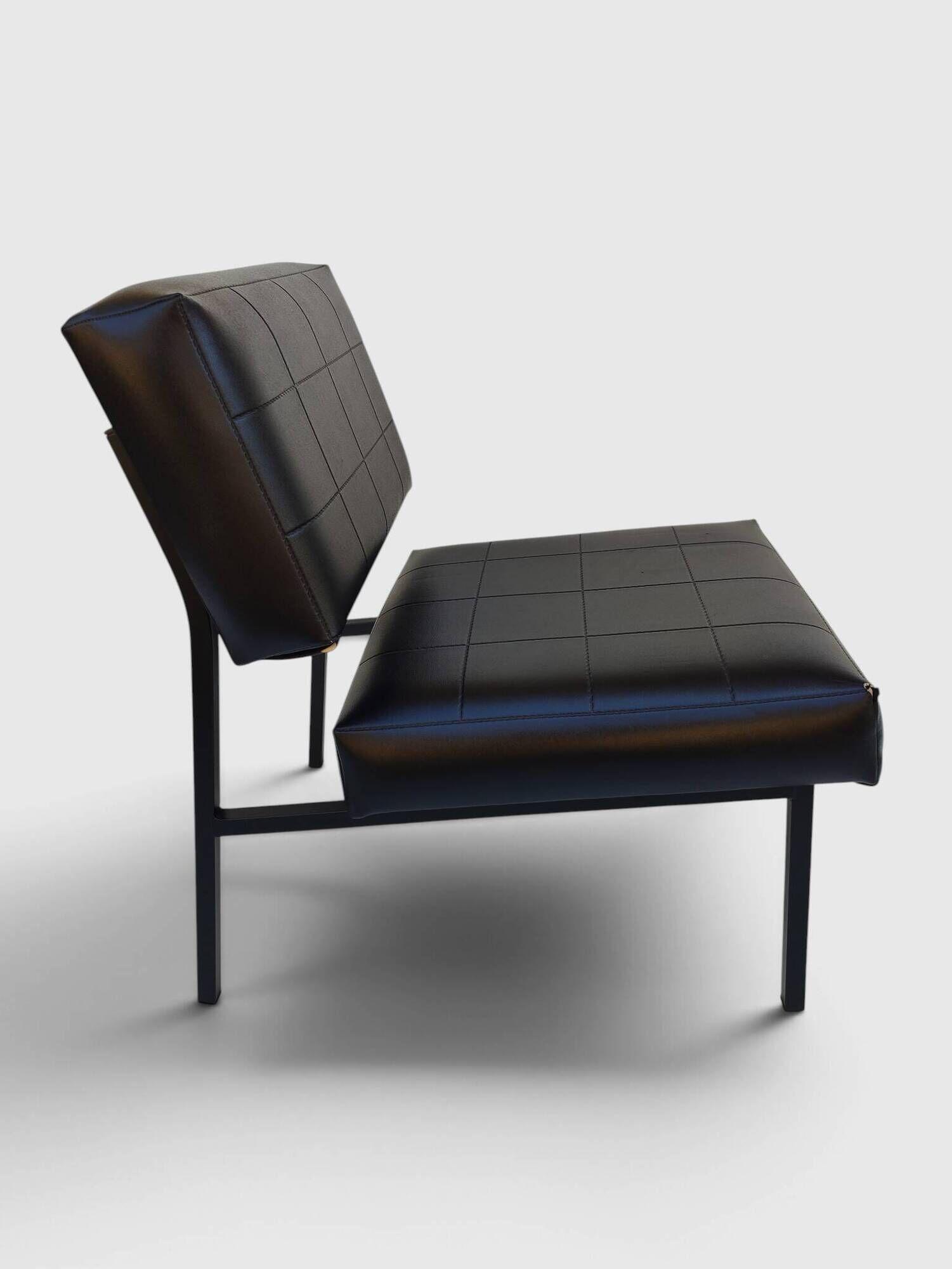 Modernist armchair in black faux leather and metal – 1960s