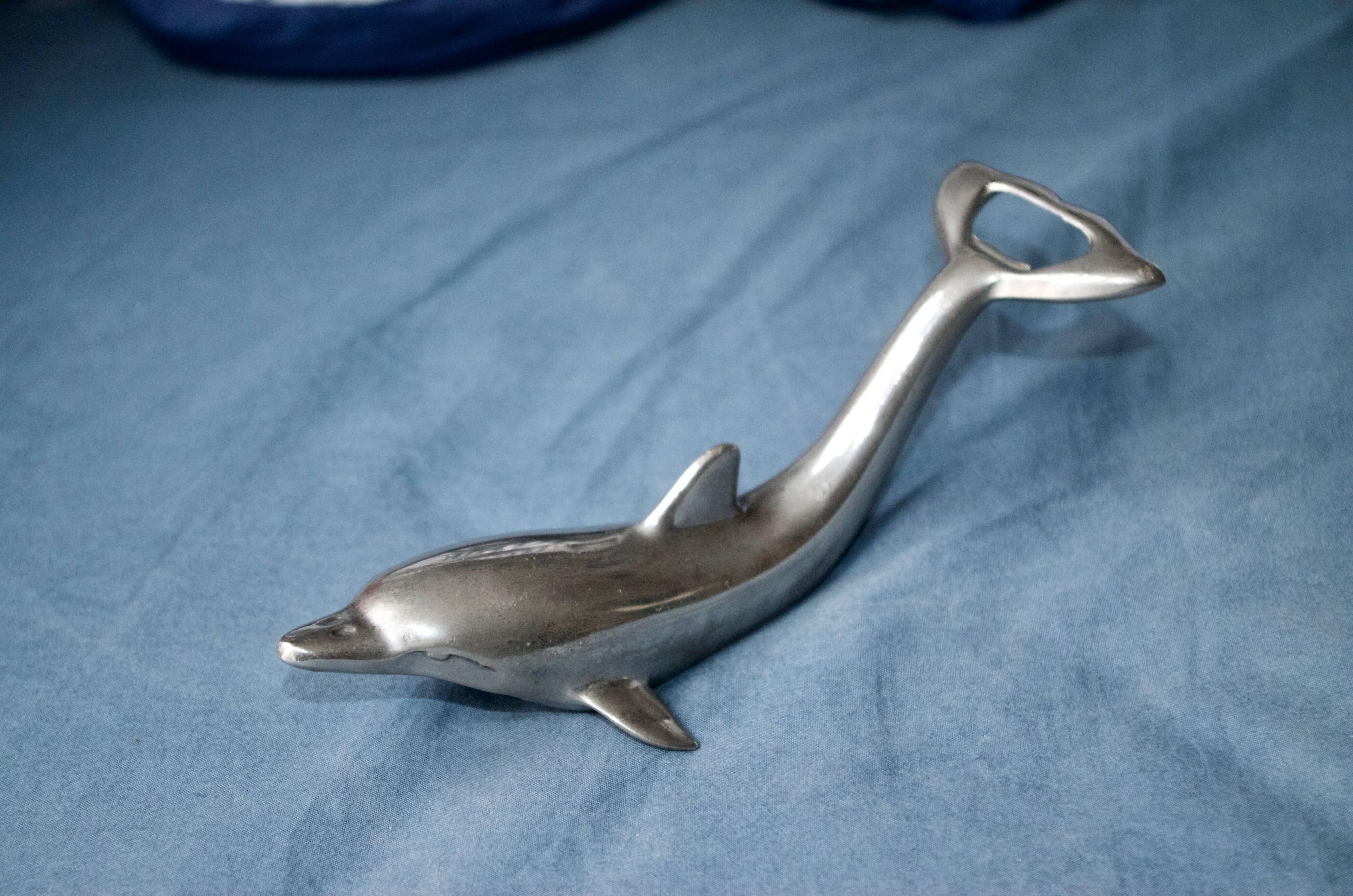 Vintage metal bottle opener dolphin