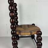 Brutalist wood turned bobbin low rush chair n the style of Charles Dudouyt